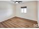 This bedroom features wood floors, neutral walls, and a modern ceiling fan at 3761 S Tumbleweed Ave, Pahrump, NV 89048