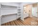 Open access to a walk-in closet and bathroom, featuring custom shelving and a vanity with great lighting at 3761 S Tumbleweed Ave, Pahrump, NV 89048