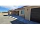 This single-story home has a tile roof and tan stucco exterior with a two-car garage at 3761 S Tumbleweed Ave, Pahrump, NV 89048
