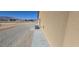 Home exterior with neutral siding, smooth gray cement patio, and air conditioning unit at 3761 S Tumbleweed Ave, Pahrump, NV 89048