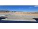 Landscape view of land, fencing, gravel driveway and mountain views in the distance at 3761 S Tumbleweed Ave, Pahrump, NV 89048
