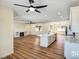 Open-concept living area with a fireplace and a kitchen island with counter seating at 3761 S Tumbleweed Ave, Pahrump, NV 89048