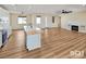 Open concept floorplan showcasing the living room, fireplace and modern kitchen at 3761 S Tumbleweed Ave, Pahrump, NV 89048