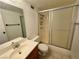 Cozy bathroom with a single sink vanity, standard toilet, and a shower enclosed with sliding doors at 3930 University Center Dr # 409, Las Vegas, NV 89119