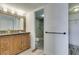 Bright bathroom with a rustic wood vanity, modern fixtures, and a walk-in shower at 3930 University Center Dr # 409, Las Vegas, NV 89119
