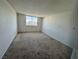 Bedroom featuring neutral carpet, a large window, and plenty of natural light at 3930 University Center Dr # 409, Las Vegas, NV 89119