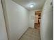 Hallway leading into the kitchen, tile flooring, overhead lighting, and textured walls at 3930 University Center Dr # 409, Las Vegas, NV 89119