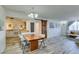 Open-concept living area features whitewashed floors, a dining area, and bright natural light at 3930 University Center Dr # 409, Las Vegas, NV 89119