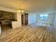 Living room with wood floors, natural light, and an adjacent kitchen featuring stainless steel appliances at 3930 University Center Dr # 409, Las Vegas, NV 89119