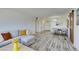 Bright living area with whitewashed flooring, comfortable seating, and view of dining area at 3930 University Center Dr # 409, Las Vegas, NV 89119