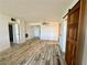 Spacious open floor plan with light-colored walls, wood-look floors, and a unique light fixture at 3930 University Center Dr # 409, Las Vegas, NV 89119
