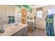 Clean and modern bathroom with dual sinks, walk-in shower, and a large window for natural light at 4754 Bluebird Cliffs Ave Dr # Lot 170, Las Vegas, NV 89141