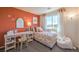 Charming bedroom with bright, floral bedding, desk, and abundant natural light at 4754 Bluebird Cliffs Ave Dr # Lot 170, Las Vegas, NV 89141