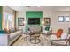 Cozy living room featuring modern furniture, a green accent wall and ample natural light at 4754 Bluebird Cliffs Ave Dr # Lot 170, Las Vegas, NV 89141