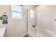 Contemporary shower with glass door, subway tile surround and window, creating a bright and clean space at 4754 Bluebird Cliffs Ave Dr # Lot 170, Las Vegas, NV 89141
