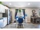 Bright dining area with a white table, blue velvet chairs, modern lighting, and stainless steel appliances at 4786 San Rafael Ave, Las Vegas, NV 89120
