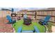 Inviting backyard firepit area with blue Adirondack chairs, a grill, and a decorative fence at 4786 San Rafael Ave, Las Vegas, NV 89120