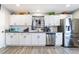 Bright kitchen with white cabinets, gray countertops, and stainless steel refrigerator at 4786 San Rafael Ave, Las Vegas, NV 89120