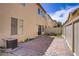 Fully fenced backyard with brick patio, small stone firepit and artificial grass at 4972 Groveland Ave, Las Vegas, NV 89139