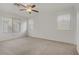 Bedroom with carpeted floor, a ceiling fan, and natural light from three windows at 4972 Groveland Ave, Las Vegas, NV 89139