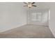 Bright bedroom features neutral carpeting, a ceiling fan, and a window for natural light at 4972 Groveland Ave, Las Vegas, NV 89139