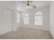 Bright bedroom with neutral carpet, ceiling fan and natural light from windows at 4972 Groveland Ave, Las Vegas, NV 89139