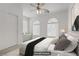 Bright bedroom with arched windows, ceiling fan, and a plush bed with elegant decor at 4972 Groveland Ave, Las Vegas, NV 89139