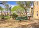 Picnic table and grill in the community park with mature trees at 4972 Groveland Ave, Las Vegas, NV 89139