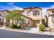 Charming two-story townhome featuring desert landscaping, a private driveway, and an attached one car garage at 4972 Groveland Ave, Las Vegas, NV 89139