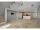 Large open-concept living area leading to kitchen with stainless appliances and ample natural light at 4972 Groveland Ave, Las Vegas, NV 89139