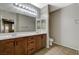 Bathroom featuring a dual sink vanity, tiled floor, and a well-lit mirror at 50 Aura De Blanco St # 19103, Henderson, NV 89074