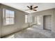 Bright bedroom with two windows, carpet flooring, ceiling fan and a closet with mirrored sliding doors at 50 Aura De Blanco St # 19103, Henderson, NV 89074