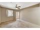 Carpeted bedroom showcases an attached balcony, neutral colored walls, and a ceiling fan at 50 Aura De Blanco St # 19103, Henderson, NV 89074