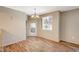 Cozy dining area with stylish chandelier and a door to the outside at 50 Aura De Blanco St # 19103, Henderson, NV 89074