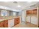 Well-lit kitchen with granite countertops that transition into an adjacent laundry area, adding to the home's convenience at 50 Aura De Blanco St # 19103, Henderson, NV 89074