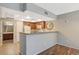 Open kitchen with granite countertops, wood cabinets, white appliances, and a stylish decorative mirror at 50 Aura De Blanco St # 19103, Henderson, NV 89074