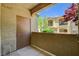 The patio of this unit overlooks other similar buildings and a gorgeous tree with bright red leaves at 50 Aura De Blanco St # 19103, Henderson, NV 89074