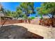 Empty backyard with brick walls and mature trees at 5588 Ness Ave, Las Vegas, NV 89118
