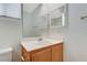 A bathroom featuring a sink with mirror and cabinet, white walls, and tile flooring at 5588 Ness Ave, Las Vegas, NV 89118