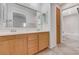 Bathroom with double vanity, tile floors, and wood cabinets at 5588 Ness Ave, Las Vegas, NV 89118