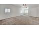 Large Primary bedroom boasting plush carpeting, white walls, and multiple bright windows at 5588 Ness Ave, Las Vegas, NV 89118