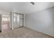 Bright bedroom with mirrored closet doors and a view of the hallway, carpeted throughout at 5588 Ness Ave, Las Vegas, NV 89118