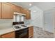 A functional kitchen featuring wooden cabinets, white appliances, and tile flooring at 5588 Ness Ave, Las Vegas, NV 89118