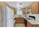 Efficient kitchen with white appliances, oak cabinets, and great lighting at 5588 Ness Ave, Las Vegas, NV 89118