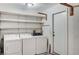 Laundry room with washer, dryer, and storage shelves at 5588 Ness Ave, Las Vegas, NV 89118