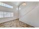 Inviting living room with high ceilings, tile floors, modern staircase, and ample natural light at 5588 Ness Ave, Las Vegas, NV 89118