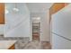 A white, organized pantry with shelving adjacent to the kitchen area for ample storage at 5588 Ness Ave, Las Vegas, NV 89118