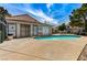 Community pool surrounded by a deck, fence, and buildings at 5588 Ness Ave, Las Vegas, NV 89118