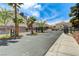 Street view of gated community with cars and trees at 5588 Ness Ave, Las Vegas, NV 89118