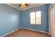 Well-lit bedroom featuring blue walls, a ceiling fan and carpeted flooring at 5772 Flying Birdie Ave, Las Vegas, NV 89122